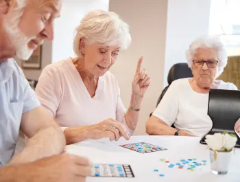 A group of older people playing bingo.
