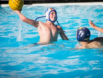 Two people playing water polo.