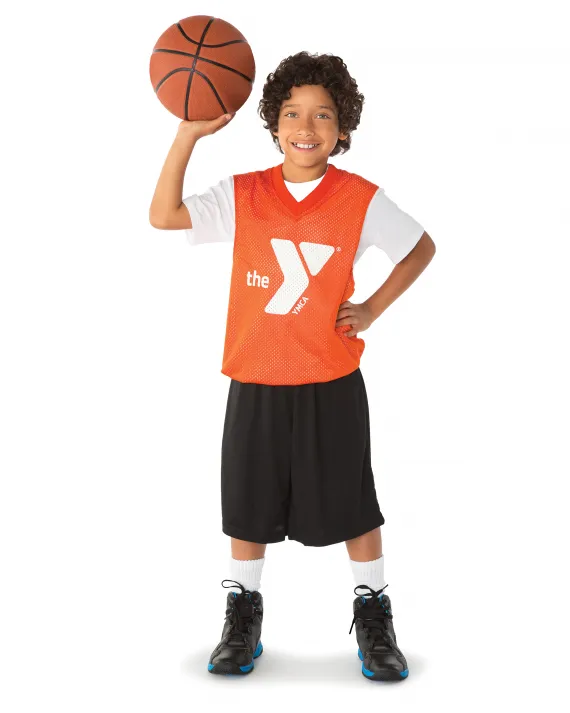 A child holding a basketball.