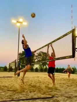 Two adults playing volleyball.