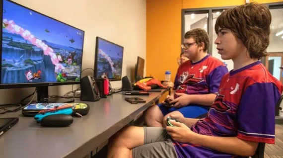 Two kids playing Super Smash Brothers Ultimate.