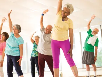 A group of older people doing a Group Exercise class.