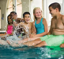 Children playing in the shallow end of a pool.