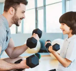 A father and son lifting weights together.