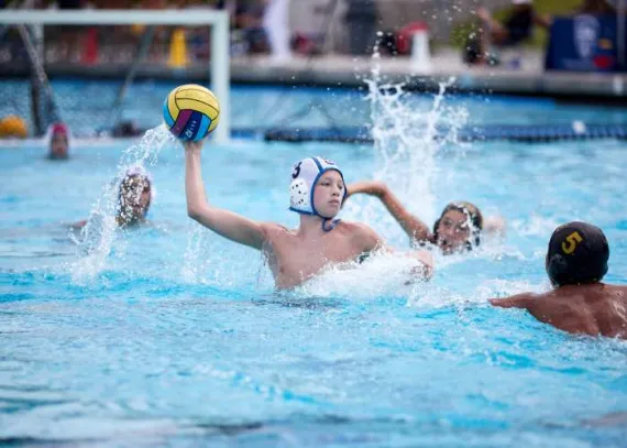 A group of people playing a game of water polo.