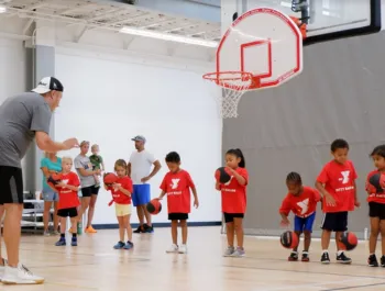 Kids lined up to practice dribbling for Bitty Ball.